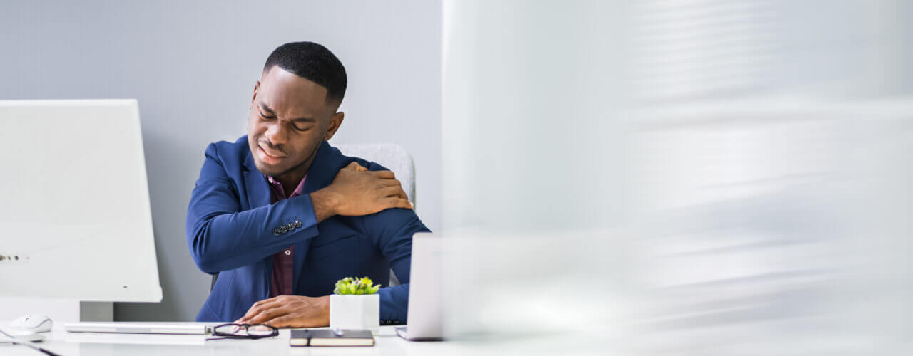 a man having Shoulder Pain in the office